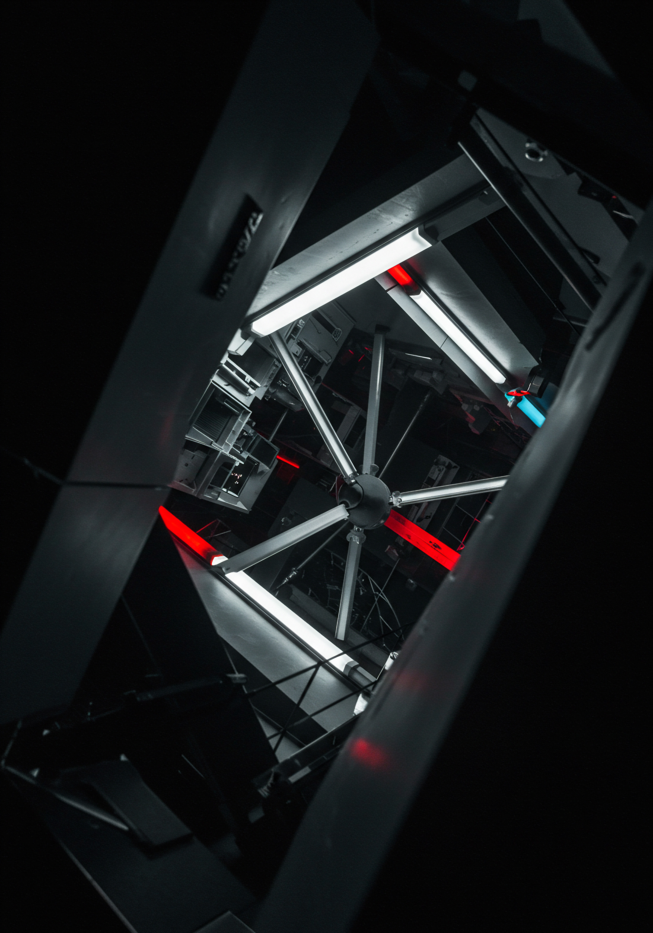 Gazing upwards reveals a striking convergence of metallic beams and artificial light sources, forming an angular, tunnel-like perspective evocative of Business automation implementation. The photograph speaks of growth potential and digital transformation within a modern Business. A Business owner might envision streamlined processes and operational efficiency through technology. Red and white lights punctuate the steel framework, emphasizing the intersection of technology and strategic planning for a small business's market expansion. The network of beams embodies the interconnectedness of systems required for successful scaling, creating a futuristic atmosphere in this workspace. Innovation emerges as the primary avenue, and highlights potential, especially regarding software solutions, to magnify results and boost revenue in the current competitive advantage market.
