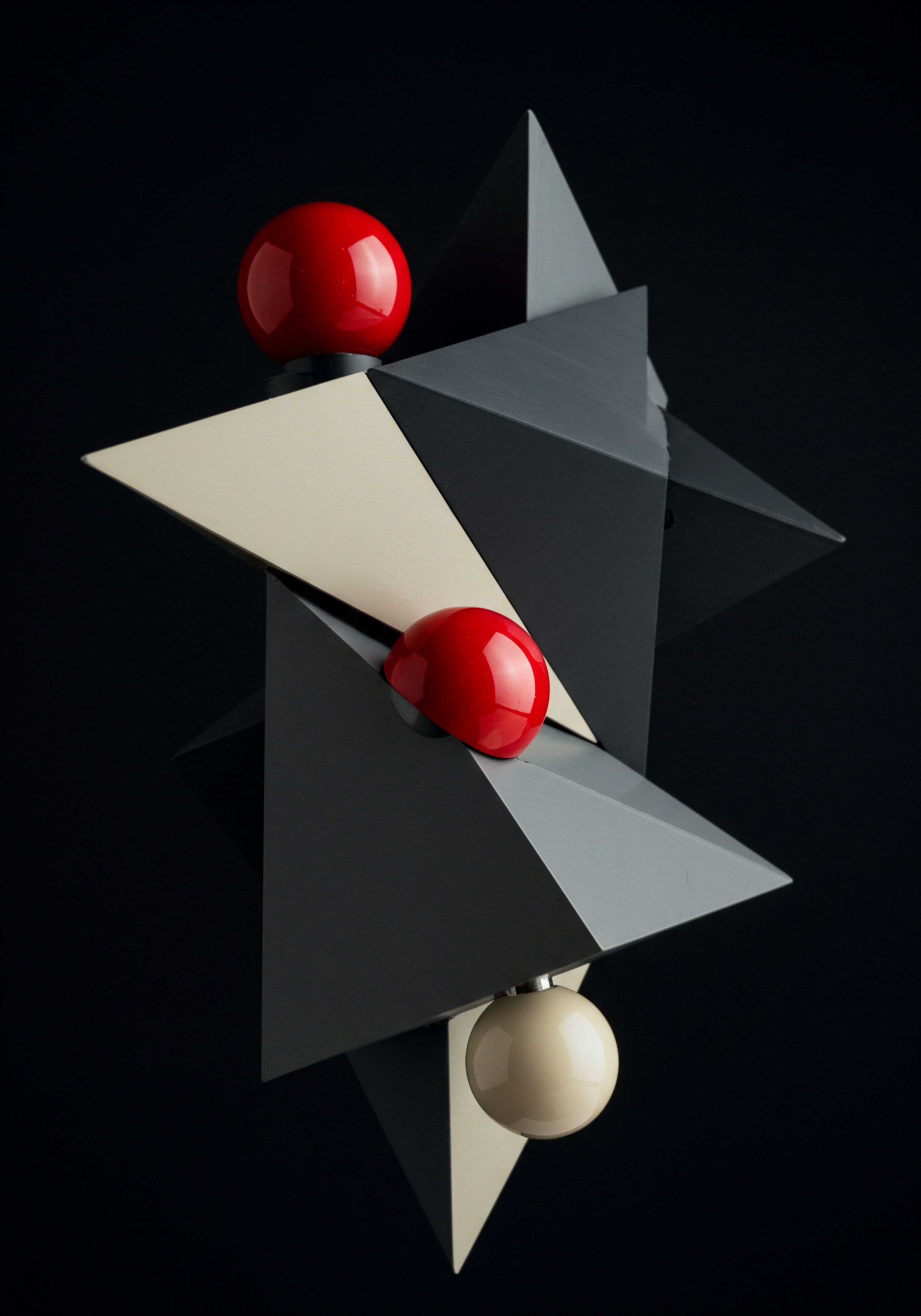 The photograph showcases an abstract geometric composition, emphasizing the interplay of red, black, cream spheres and triangular forms. The striking red balls contrast against the muted triangles creating a visual focus for growth and optimism applicable for small business and medium business models in todays marketplaces. The careful arrangement suggests a structure scaling from a smaller base to something significant, mirroring business strategy. The balanced yet dynamic arrangement brings ideas surrounding innovation. Small Business entrepreneur development and streamlined systems build competitive advantage driving progress toward success offering unique solutions and improved workflow in our data driven digital age creating a positive optimistic vision. The visual is symbolic of an organization's vision for potential market share in an ever expanding global economy as it seeks opportunities for investment and profit. Technology provides agile modern improvements allowing teams to optimize services.
