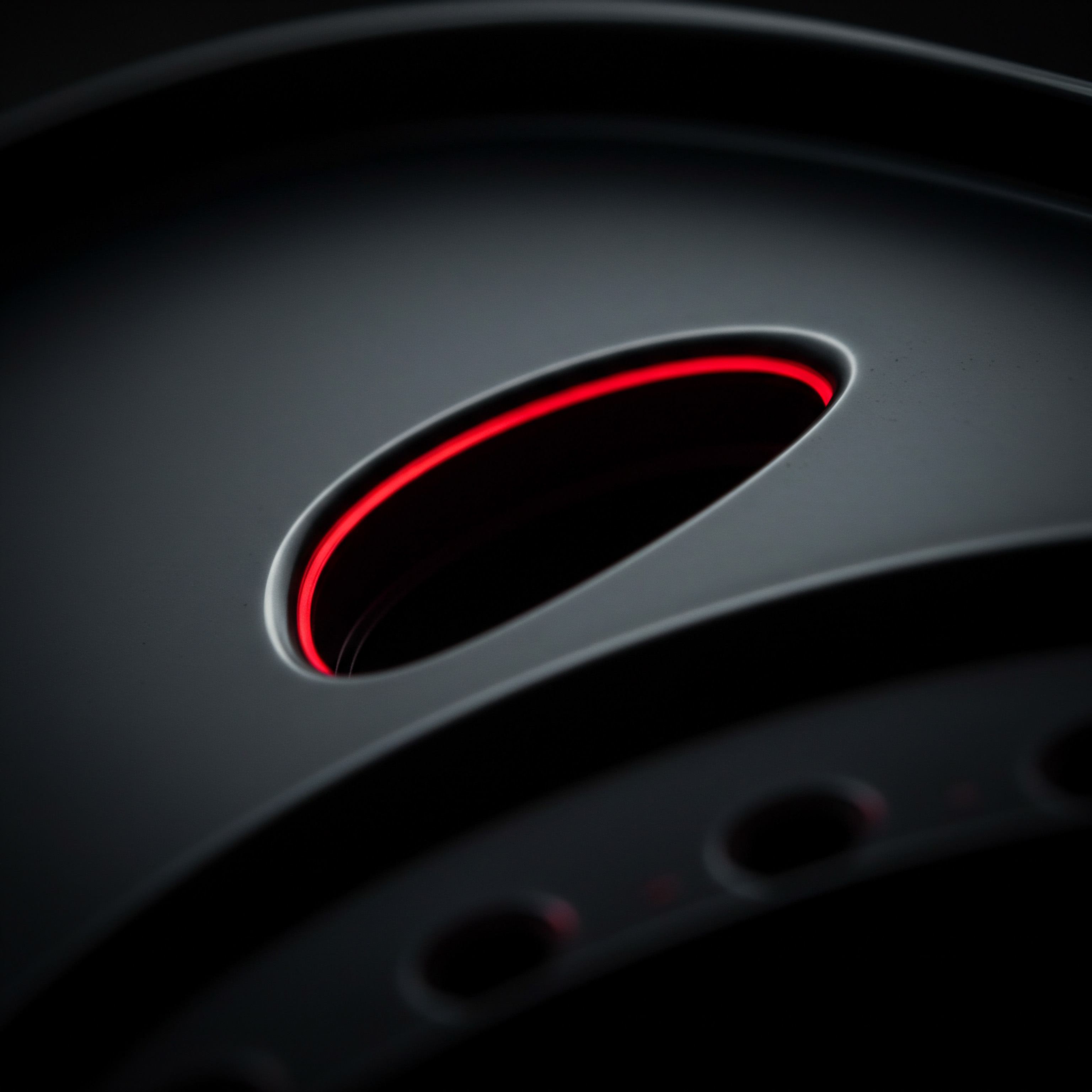 A close up shot displays a sleek, gray metallic component. A single, rounded triangular slot is prominently featured, brightly lined with a radiant red glow, creating a stark contrast. Below the slot, smaller circles hint at further intricate engineering within this piece of equipment. The dramatic lighting emphasizes smooth contours and precise construction that highlights operational efficiency, growth strategy, automation strategy that small business owners and entrepreneurs consider for digital transformation for SaaS and cloud computing adoption. The image suggests innovation trends and business technology that could translate to market expansion as a product that offers service, business consulting, data analytics, problem solving with digital tools, collaboration between team to achieve shared success, building innovation culture with support. The metallic object can be applied for marketing and sales as solution in the competitive marketplace.