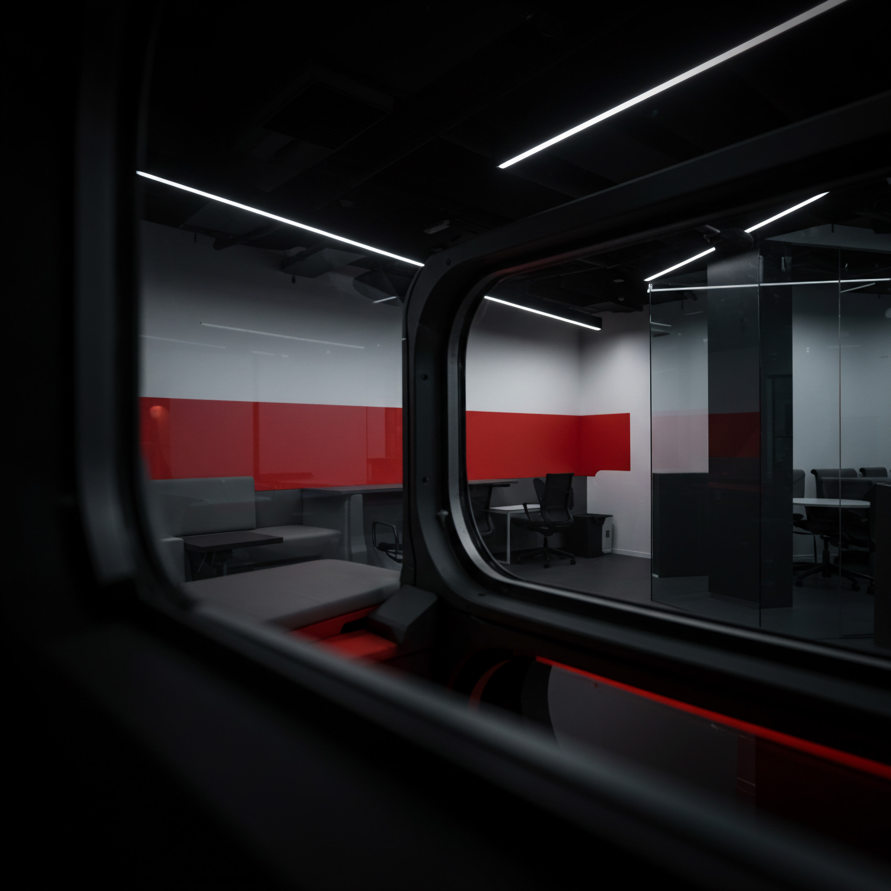 Modern SMB Office Space Reflecting Innovation Scaling Business Growth Strategy and Collaboration Observed through a distinctive frame, a Small Business workspace reflects scaling, collaboration, innovation, and a growth strategy. Inside, a workstation setup evokes a dynamic business environment where innovation and efficiency work in synchronicity. The red partitions add visual interest suggesting passion and energy for professional services.