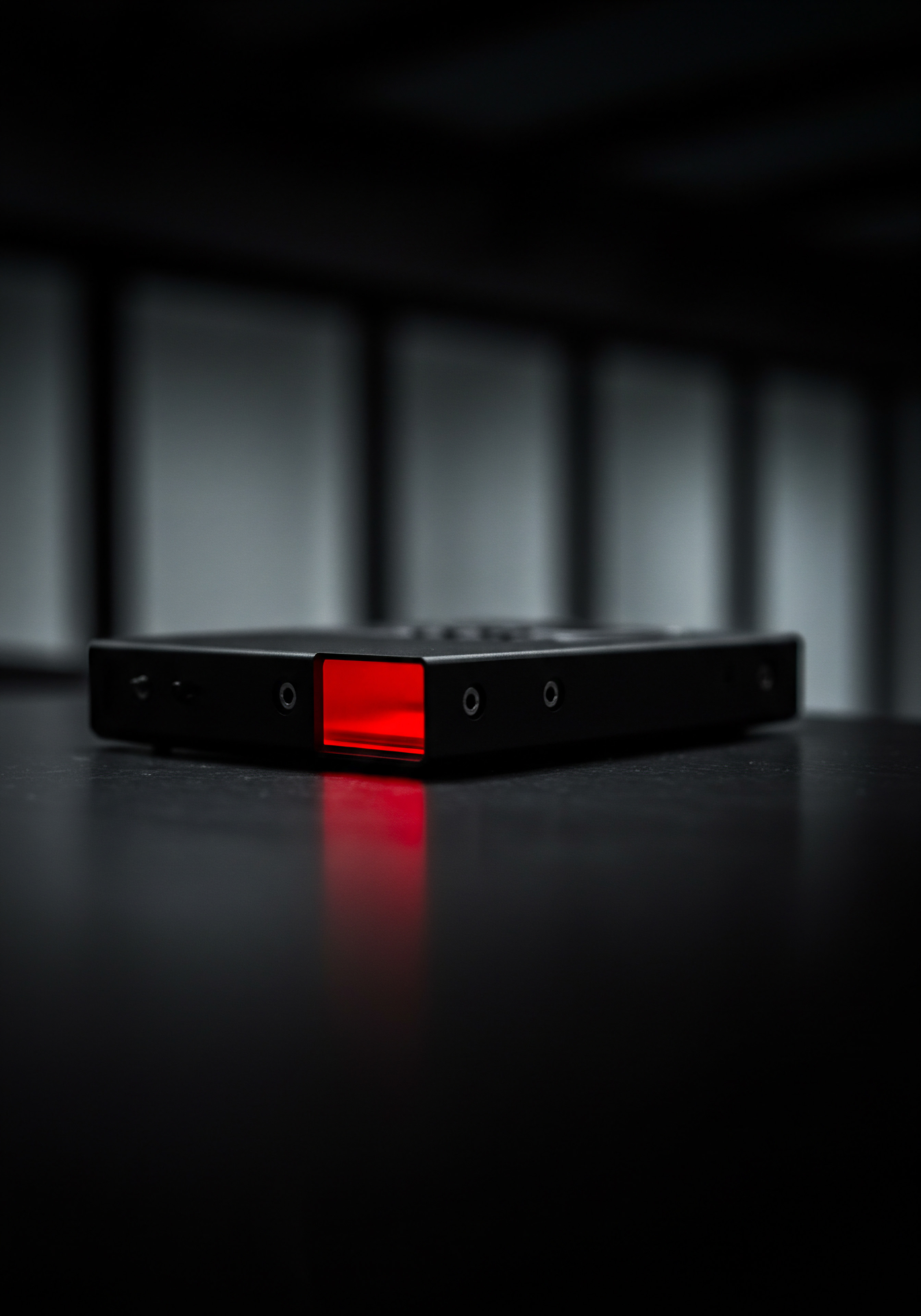 Red Illumination and Sleek Black Technology for Business Automation Solutions SMB On a polished desk, the equipment gleams a stark contrast to the diffused grey backdrop highlighting modern innovation perfect for business owners exploring technology solutions. With a focus on streamlined processes and performance metrics for SMB it hints at a sophisticated software aimed at improved customer service and data analytics crucial for businesses. Red illumination suggests cutting-edge technology enhancing operational efficiency promising a profitable investment and supporting a growth strategy.