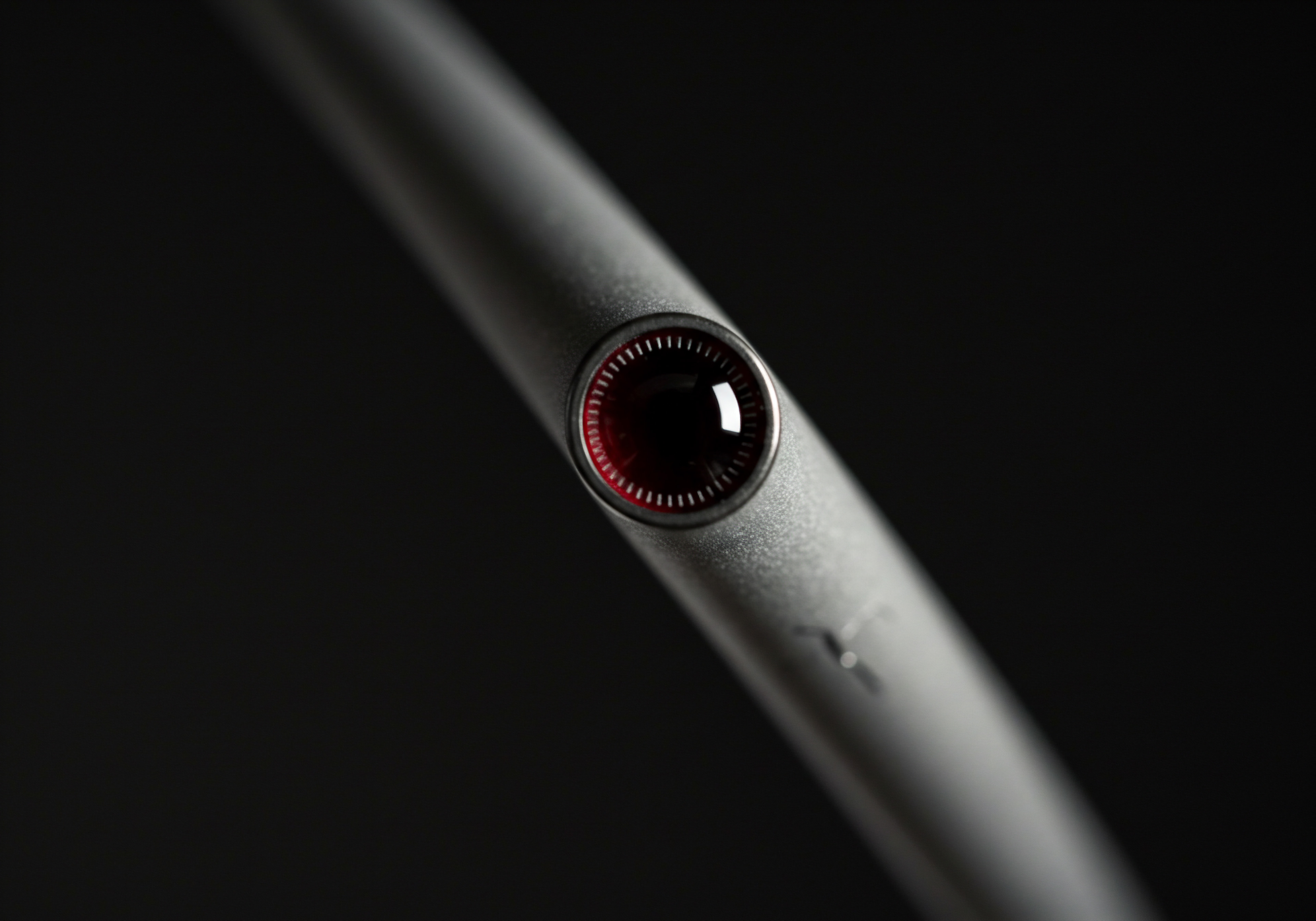 Strategic Focus Silver Device Red Detail Automation for Medium Business Growth Captured close-up, the silver device with its striking red and dark central design sits on a black background, emphasizing aspects of strategic automation and business growth relevant to SMBs. This scene speaks to streamlined operational efficiency, digital transformation, and innovative marketing solutions. Automation software, business intelligence, and process streamlining are suggested, aligning technology trends with scaling business effectively.