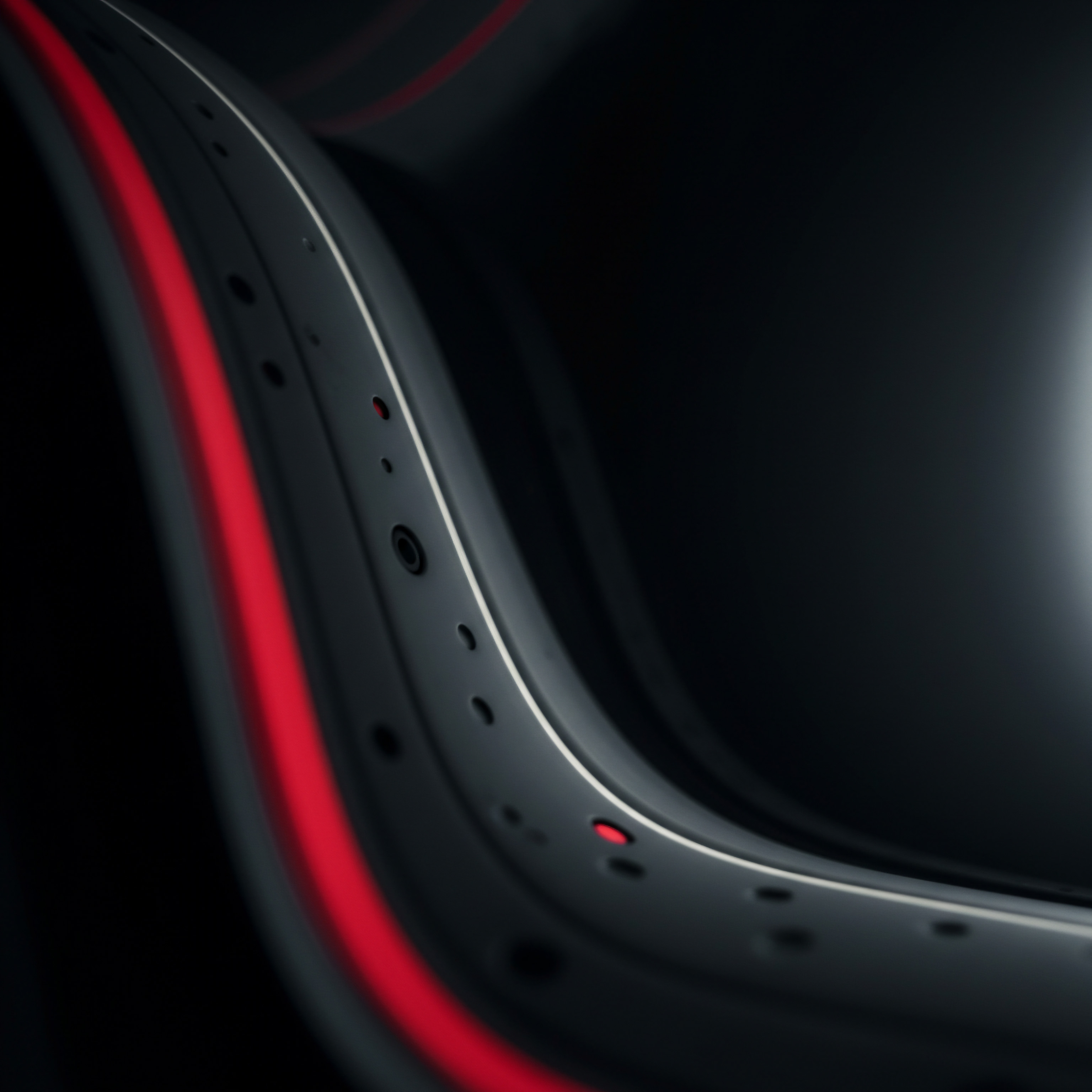 A sleek, close-up perspective reveals a modern, curving structure that suggests forward momentum for an SMB business. It is finished in a dark, sophisticated hue with striking red accents, hinting at the energy of a startup. Small perforations punctuate the design, reminiscent of a digitally automated system that enhance the workflows of Business owners to gain workflow optimization and strategic planning for a growing business. This visual evokes Business intelligence, streamlined services, and scalability through the implementation of cloud computing, SaaS, and a focus on efficiency, while promoting Innovation and a strategic solution for problem-solving, which allows for improvement and Growth, all with a clear Vision in marketing for the competitive Market. Technology and its support is present in the connection and network created for success.