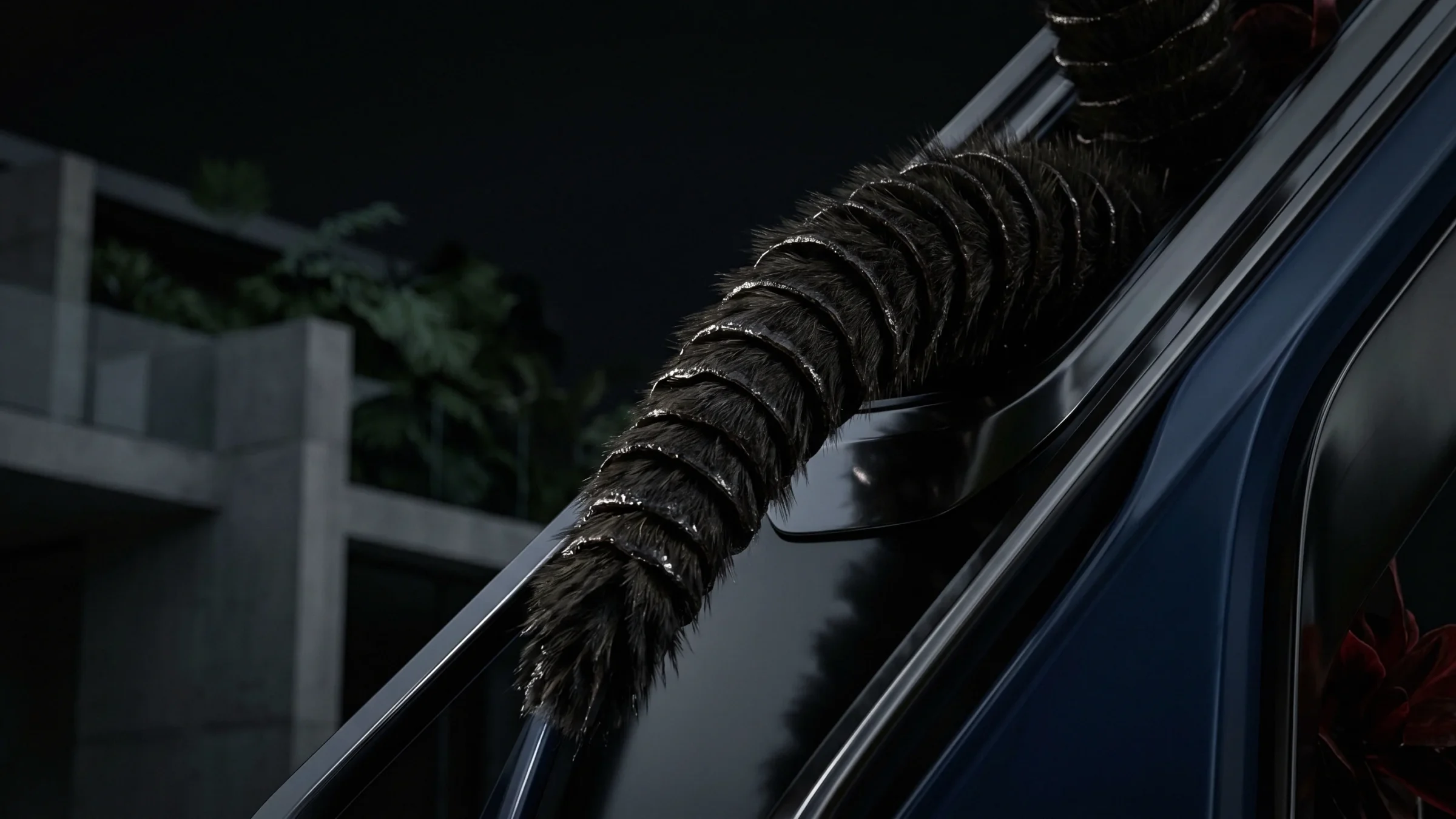 A barred, furry tail and feathers curve over a polished rail, with concrete planters behind.